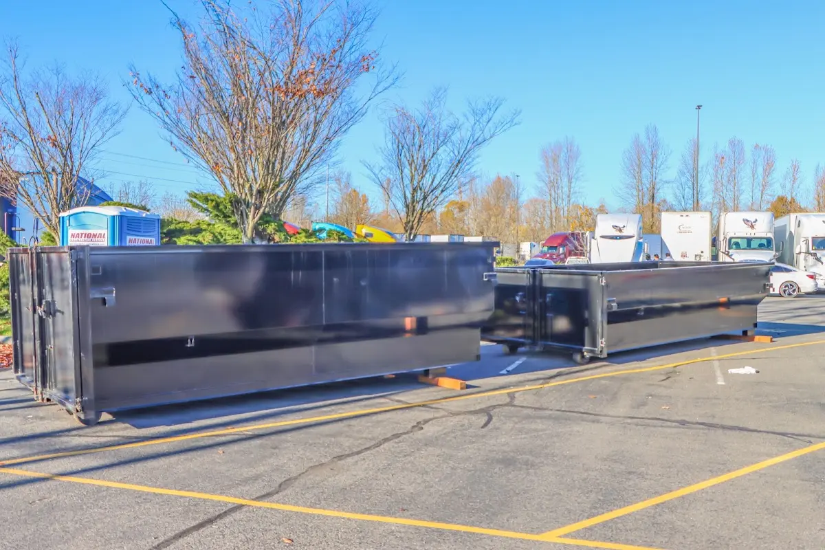 Professional dumpster rental service with roll-off container on residential driveway in Metropolis